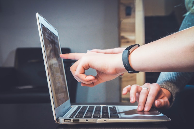 Person reviewing transcription on a laptop